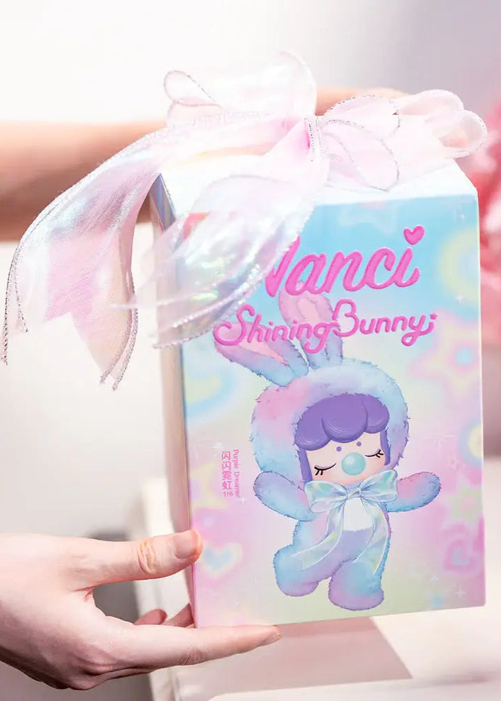 Product packaging with a character design and 'nanci' branding, held by a person.